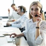 Female,Customer,Support,Operator,With,Headset,And,Smiling